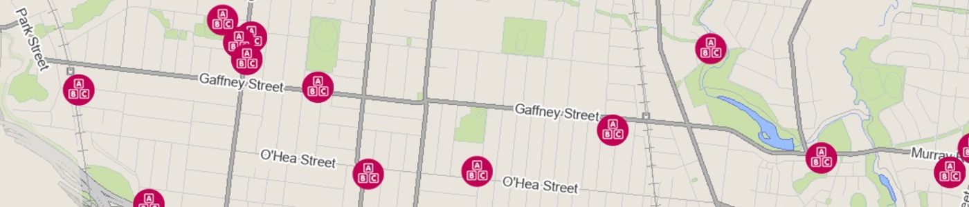 A street map in beige and green with red circles that represent kindergartens A street map in beige and green with red circles that represent kindergartens