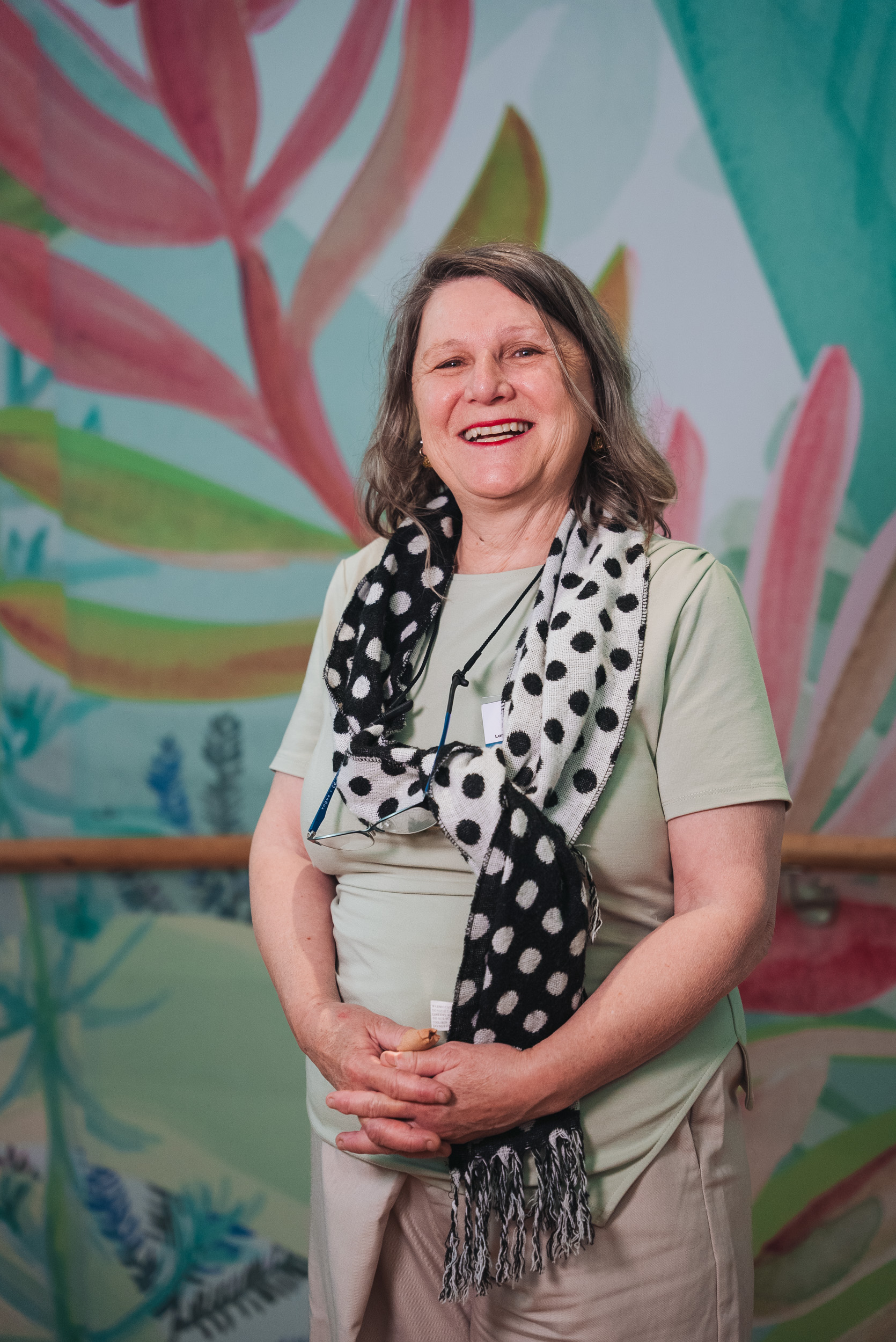 A person wearing a polka dot scarf. A person wearing a polka dot scarf.