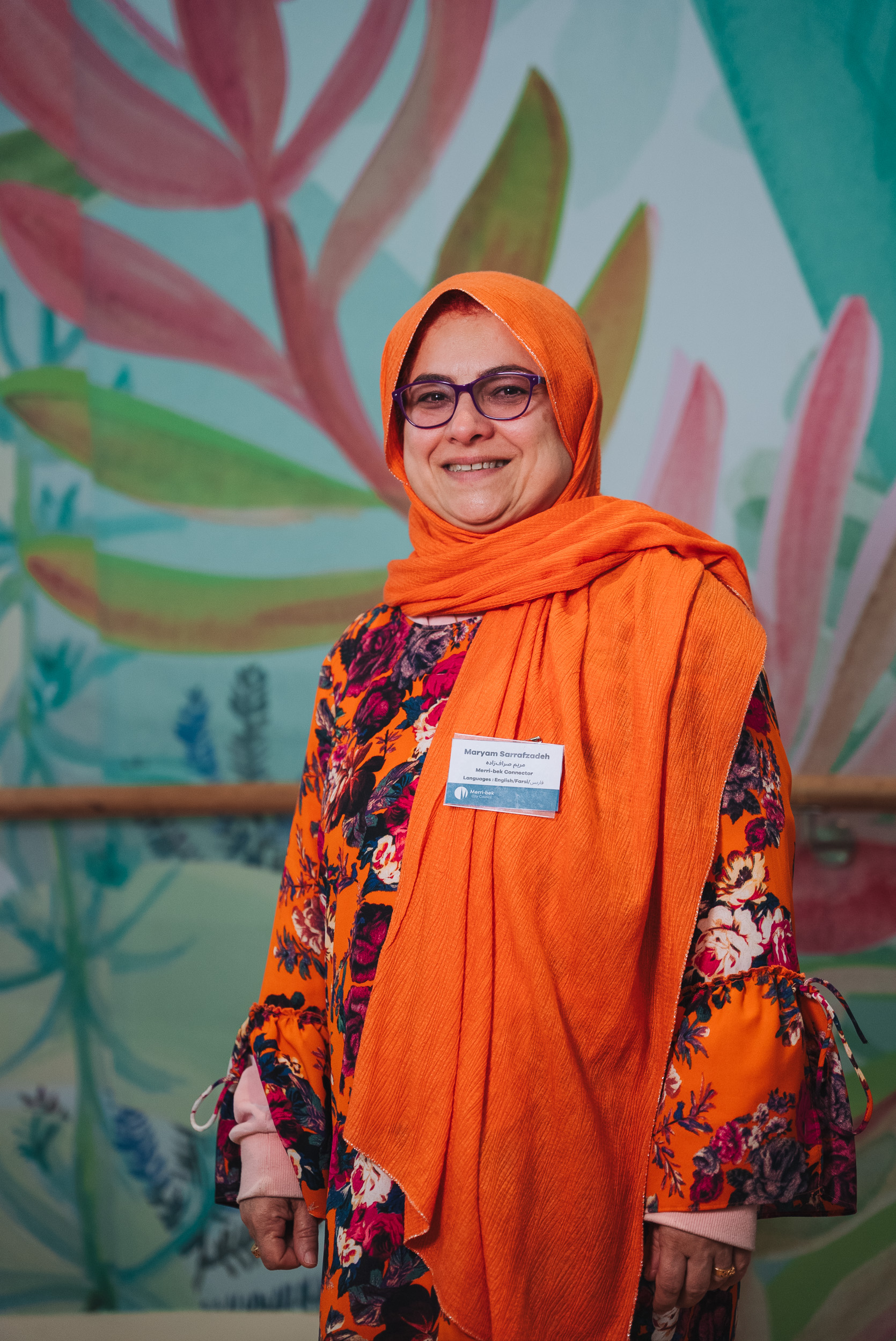 A person wearing a orange hijab. A person wearing a orange hijab.