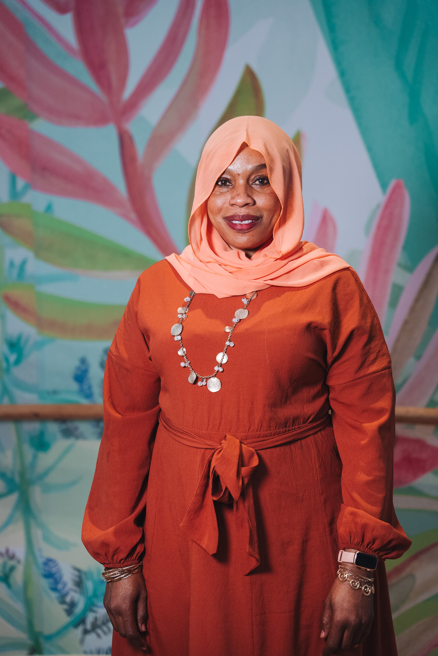 A person wearing a hijab and suit A person wearing a hijab and suit