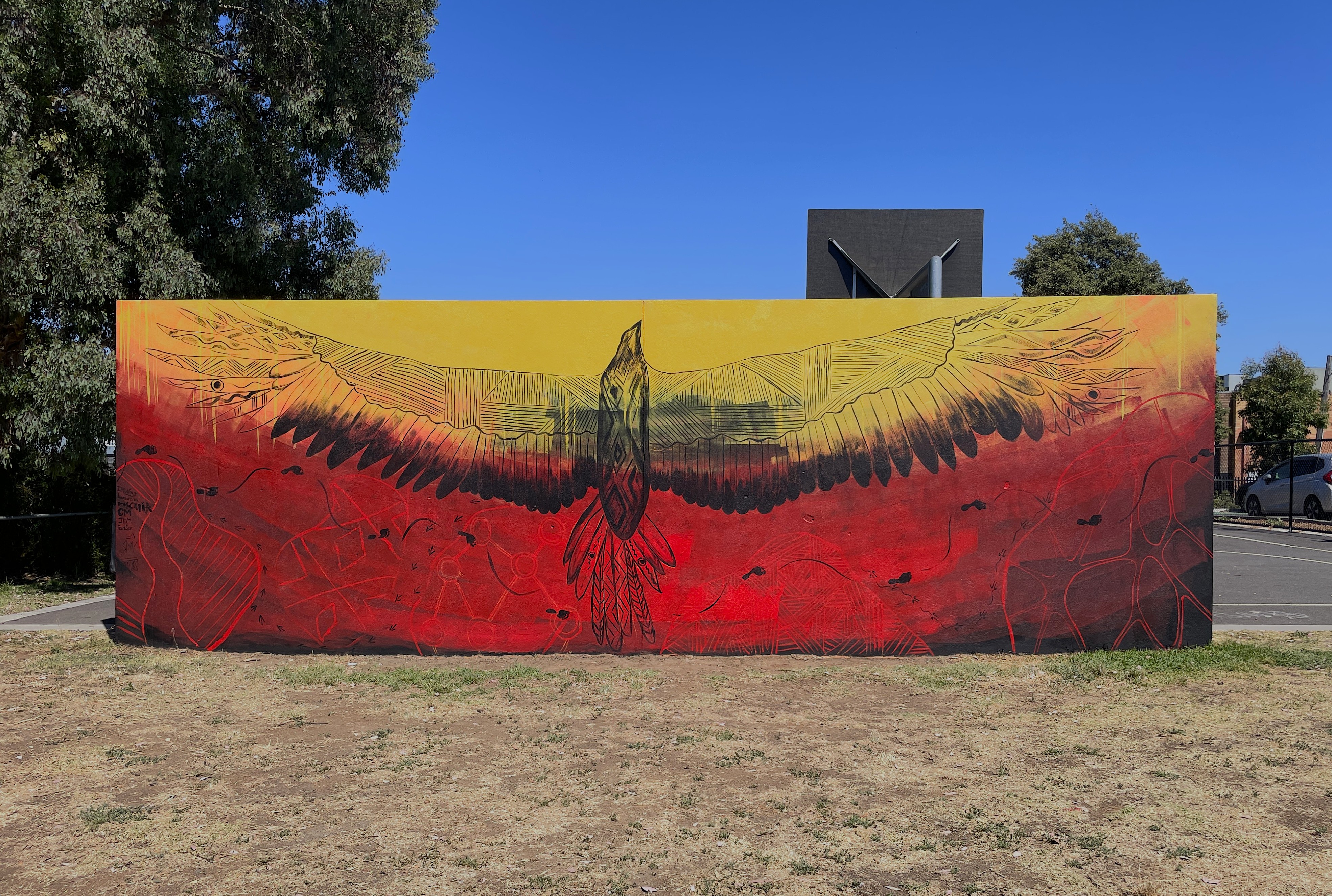 mural painting of Bunjil over red yellow and black mural painting of Bunjil over red yellow and black